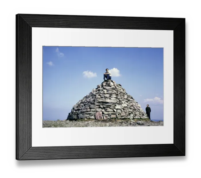 Framed Print : Young man sitting on a cairn on the summit of Dunkery Beacon, the highest point in Exmoor National Park, Somerset, England 1, 705 ft 520 metres, 1967