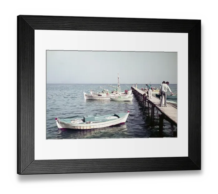 Framed Print : Tourists on the shore on the pier with a view of a fishing boat, Kos, Greece 1970s Framed Print : Tourists on the shore on the pier with a view of a fishing boat, Kos, Greece 1970s