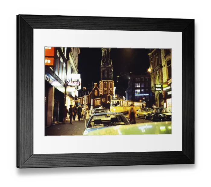 Framed Print : Neon lights in the city centre of Amsterdam at night, Netherlands 1970s 1980s, yellow Munttoren tram tower