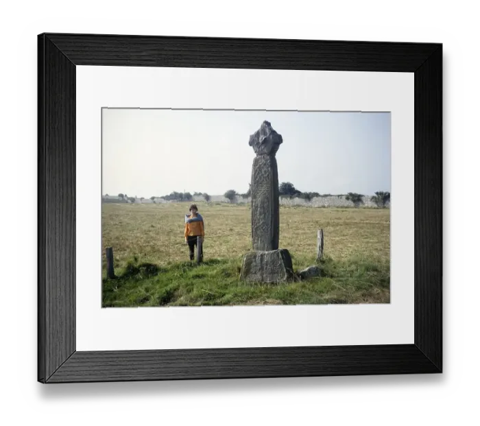 Framed Print : Woman standing in the field at Penmon Cross c. 1000 AD, Penmon Priory, Anglesey, North Wales, UK 1966 Framed Print : Woman standing in the field at Penmon Cross c. 1000 AD, Penmon Priory, Anglesey, North Wales, UK 1966