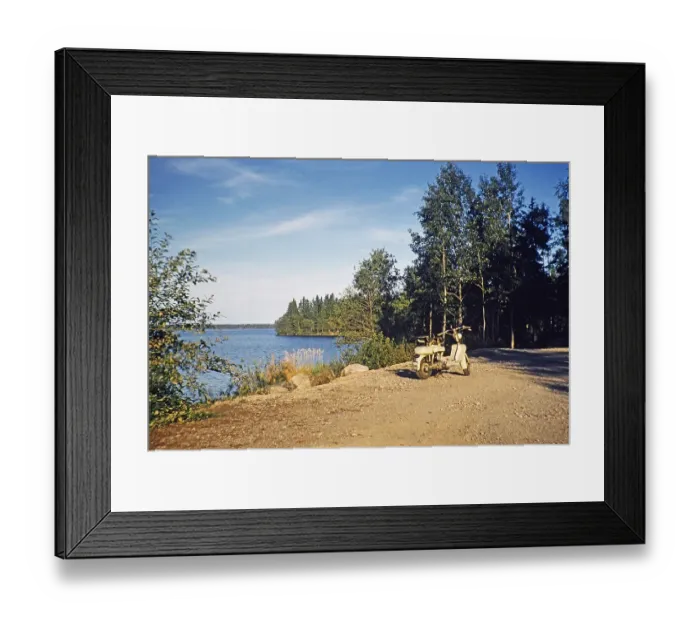 Framed Print : Motorised scooter by a lake in a rural setting, Sweden 1958