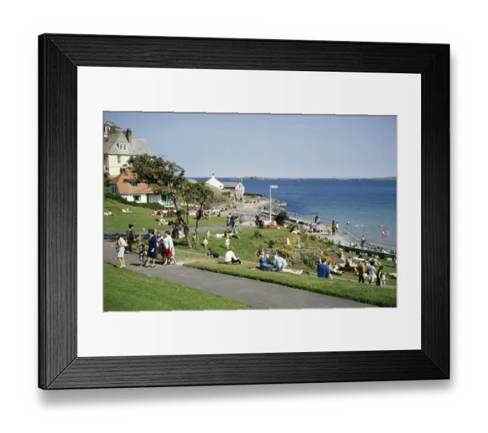 Framed Print : People sittng on grass by the coast enjoying sunshine at the seaside resort of Portrush, County Antrim, Northern Ireland, UK 1960s