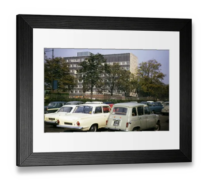 Framed Print : Cars in a car park next to a large modern office building, Great Britain 1966, location unknown