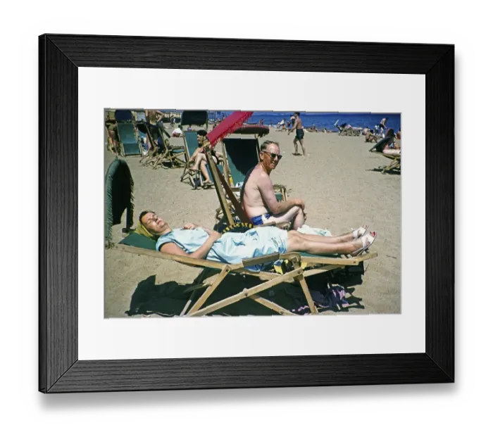 Framed Print : People sunbathing in deckchairs on the sandy beach of the Mediterranean Sea, Barcelona, Catalonia, Spain July 1958