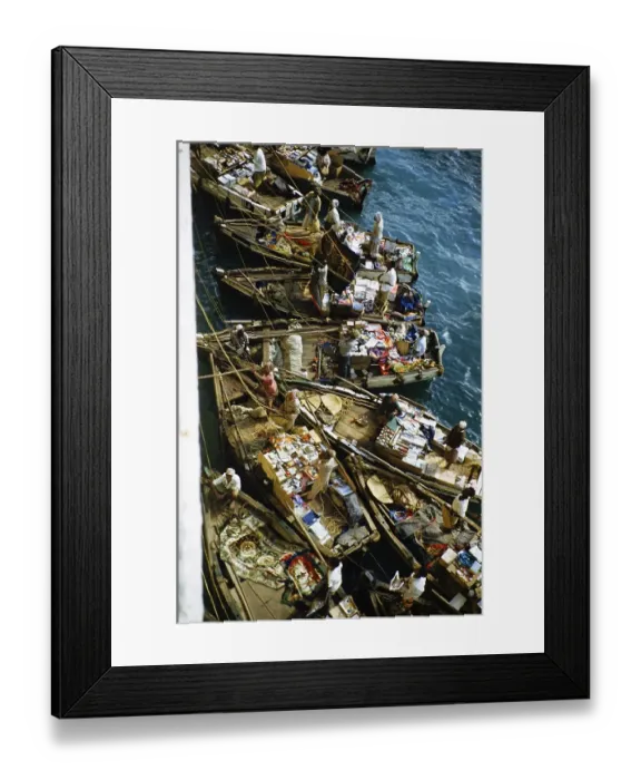 Framed Print : Small open boats in which merchants sell souvenirs and products to the passengers of a ship, Aden, Yemen 1956