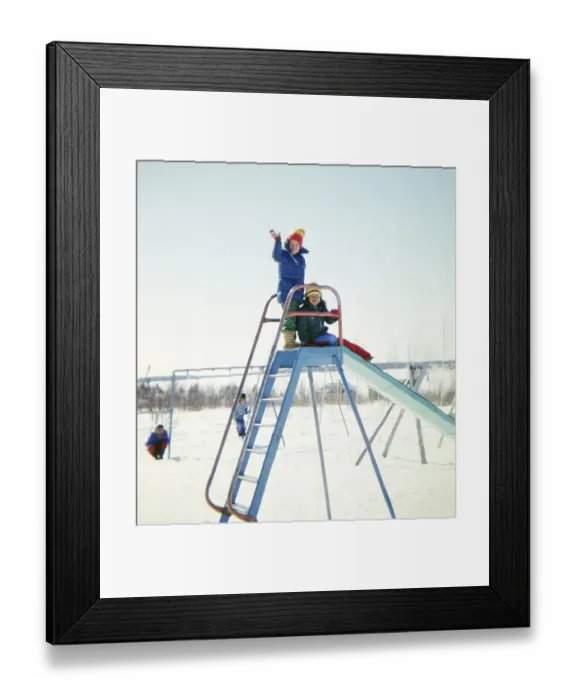 Framed Print : Ojibway community of Webequie First Nation, Eastwood Island, Northern Ontario, Canada 1978 Children playing on a slide at a playground