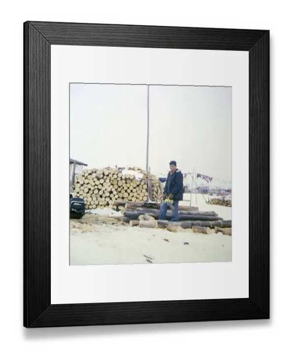 Framed Print : Ojibway community of Webequie First Nation, Eastwood Island, Northern Ontario, Canada 1978 Man at work with a chainsaw sawing wood
