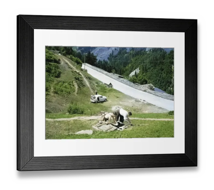 Framed Print : Men making tea and food, British Austin Cambridge A40 car in Austria, overland drive adventure across Europe, 1956 colourised Ektachrome slide