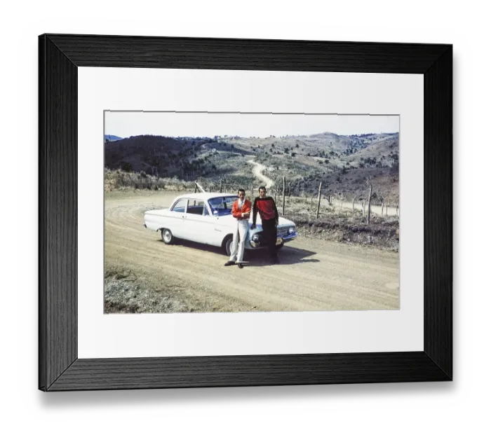 Framed Print : Two men standing next to a Ford Falcon in a hilly landscape in the countryside, Cuba around 1960