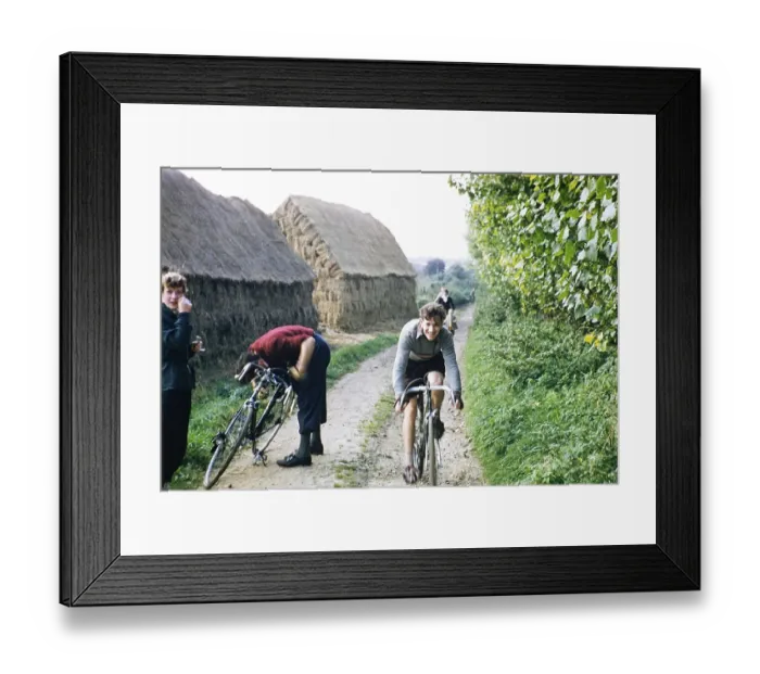 Framed Print : Young men in a cycling club ride their bicycles past haystacks on a country lane, Kent, England, UK 1956