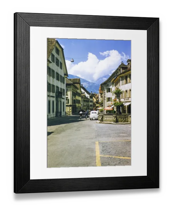 Framed Print : Historic buildings, shops, water fountain in the street with Hotel Schwarzer Loewen, Altdorf, Canton Uri, Switzerland, Europe, 1950s, Europe