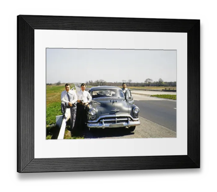 Framed Print : Three men in business suits standing next to an Oldsmobile 88 on a motorway, USA around 1953