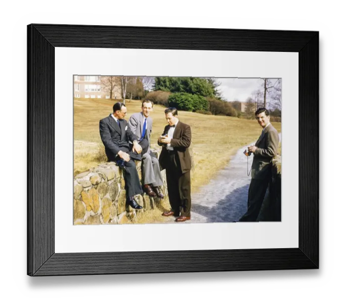 Framed Print : Four elegantly dressed men in business suits outdoors, USA around 1953, standing, sitting against the wall