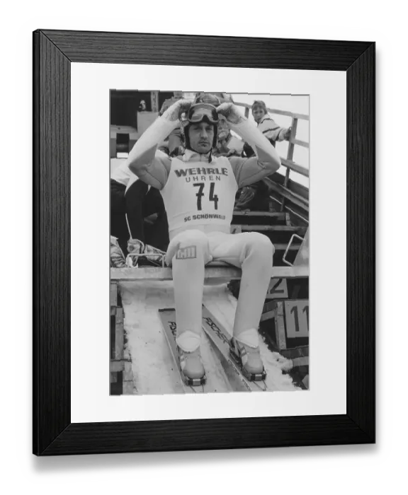 Framed Print : World Cup, ski jumping, Ingo Lesser (DEU) sits on the jumping hill and adjusts his helmet as he prepares to jump, 1991, Germany, Europe