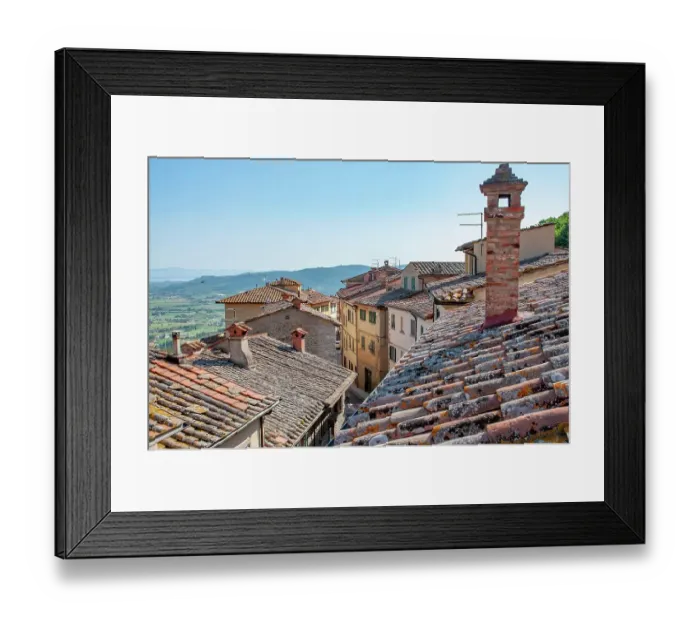 Framed Print : Picturesque italian village showing terracotta roofs and brick chimneys overlooking a valley