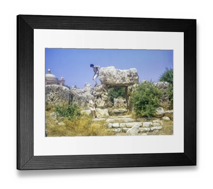 Framed Print : Neolithic temples of Skorba prehistoric archaeological site, Mgarr, Malta, Europe 1971 young man climbing on stones, Europe