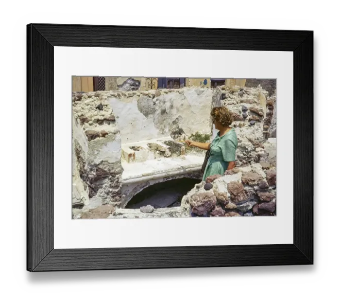 Framed Print : Female woman tourist looking at ruins of old domestic kitchen, Oia, Santorini, Cyclades islands, Greece, Europe, 1972, Europe