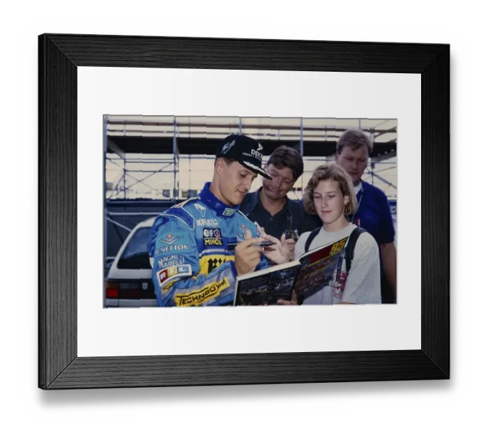 Framed Print : Racing driver Michael Schumacher (Benetton Ford), in blue racing suit gives a fan an autograph, Formula 1 Grand Prix at the Hockenheimring on 30 June 1995, Germany, Europe