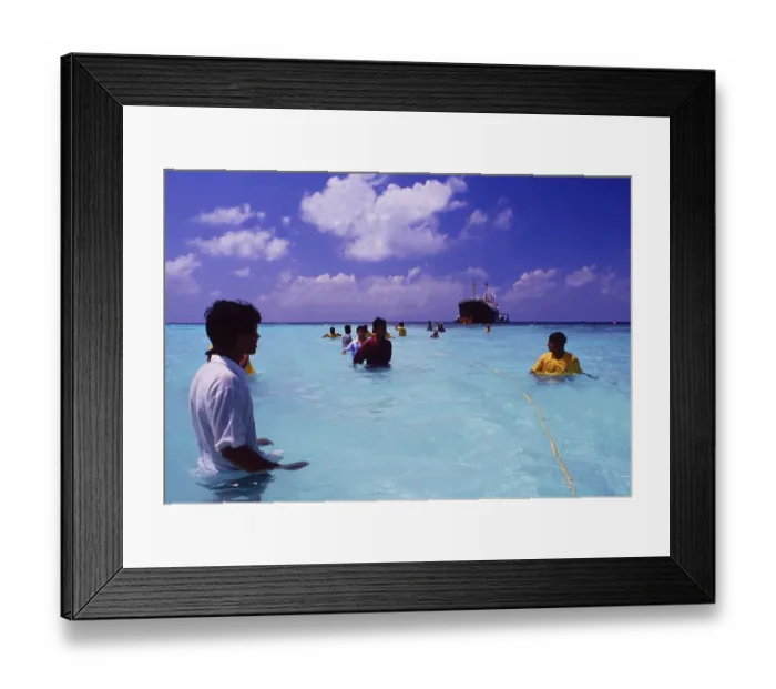 Framed Print : Maldives: People pull a cargo ship towards Makafushi Island to sink it and create a new environment for marine life