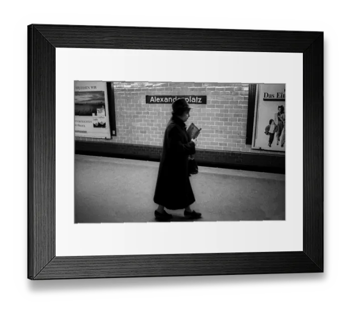 Framed Print : Germany, Berlin, 14.02.1992, Woman with hat and newspaper, underground station Alexanderplatz, Europe