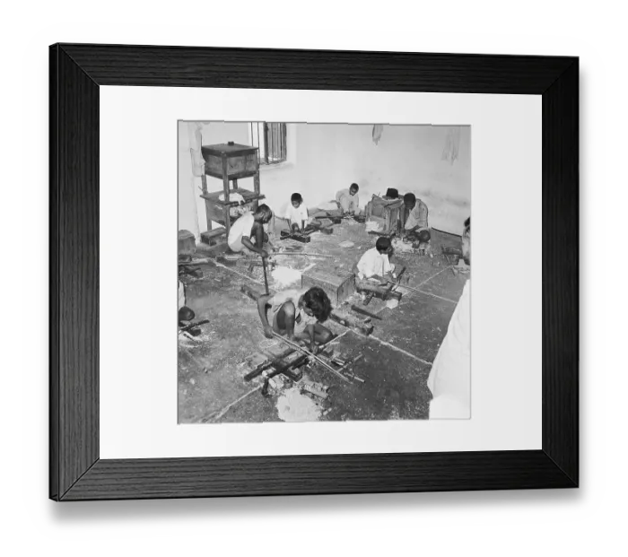 Framed Print : Young boys using portable rotating lathe applying lacquer wringtinforia wood, painting lacquer toys, Channapatna, Karnataka