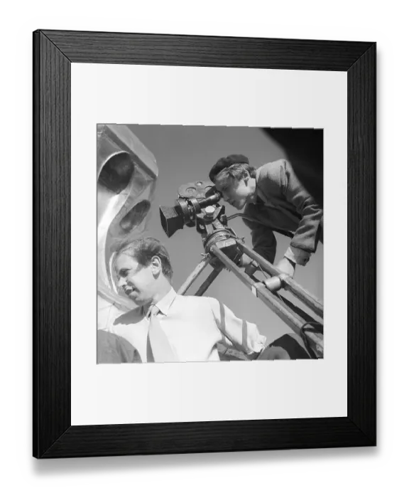 Framed Print : Bold filming on the roof of the City Hall Tower in Stockholm in the 1940s. Two young men with a film camera are perched on the copper roof of the City Hall Tower. The lightweight and smaller film camera being used is mounted on a tripod
