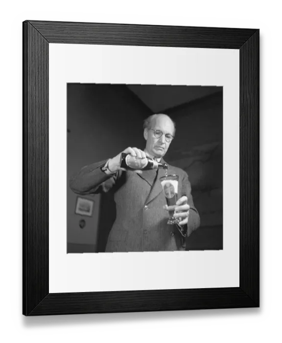 Framed Print : Erik Olson (1886-1966) Swedish industrialist. Head of the Pripp & Lyckholm brewery in Gothenburg. He is seen pouring the content of a bottle of beer of his own companies production into a beer glass. 1943 Framed Print : Erik Olson (1886-1966) Swedish industrialist. Head of the Pripp & Lyckholm brewery in Gothenburg. He is seen pouring the content of a bottle of beer of his own companies production into a beer glass. 1943