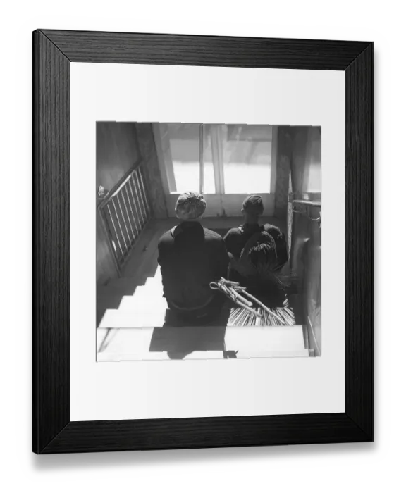 Framed Print : Sweepers in 1940. Two chimney sweeps are resting on the stairs in a doorway, perhaps chosen because it is a cooler place to sit and take a break than on the hot rooftop on this hot summer day in June 1940. Kristoffersson ref 154-8