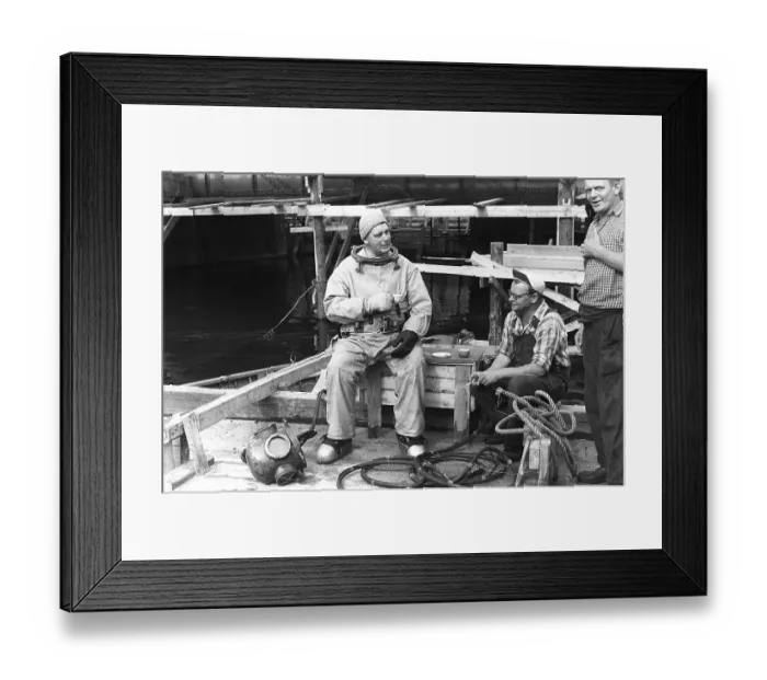 Framed Print : A diver in 1953, sitting in his diving suit and drinking coffee Framed Print : A diver in 1953, sitting in his diving suit and drinking coffee