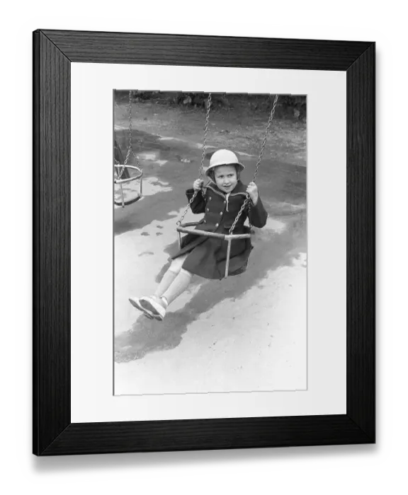 Framed Print : A girl in a playground in 1953. A girl dressed in fancy clothes and a hat is sitting in a swing in a playground. Kristoffersson ref 1-11 Framed Print : A girl in a playground in 1953. A girl dressed in fancy clothes and a hat is sitting in a swing in a playground. Kristoffersson ref 1-11