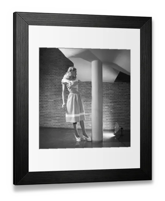 Framed Print : Fashion 1946, a young blonde female model dressed in the fashion of the year. Her sleeveless dress has a polka-dot pattern and is of a summery, lightweight type with a narrow waist and a length that reaches below the knees