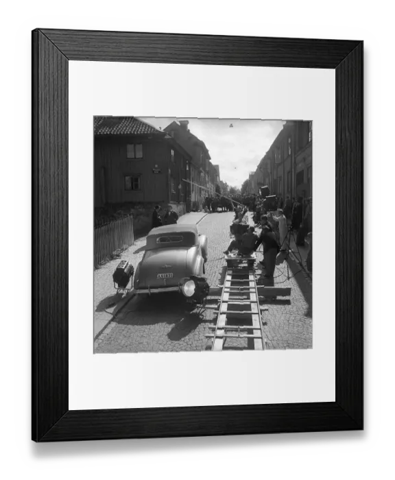 Framed Print : Foer min heta ungdoms skull 1952. Drama film directed by Arne Mattsson. The picture shows filming in Uppsala. The film camera is mounted on a moving platform on rails that follows the actors and the car when it is moving