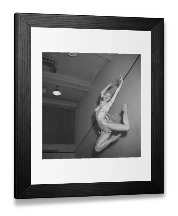 Framed Print : Amy Aaroee. Swedish actress and dancer (1925-2024) Here in her stage costume as she jumps high into the air and is caught in the hundredth of a second when she looks her best. 1947. Kristoffersson ref AA26-7
