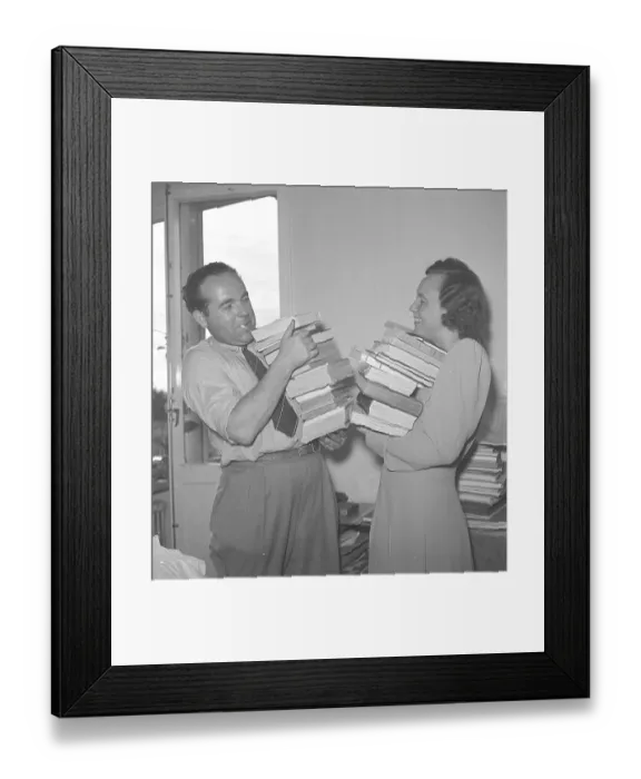Framed Print : With books in their arms 1945. A man and a woman standing holding a stack of books in their arms. 1945. Kristoffersson ref O139-5
