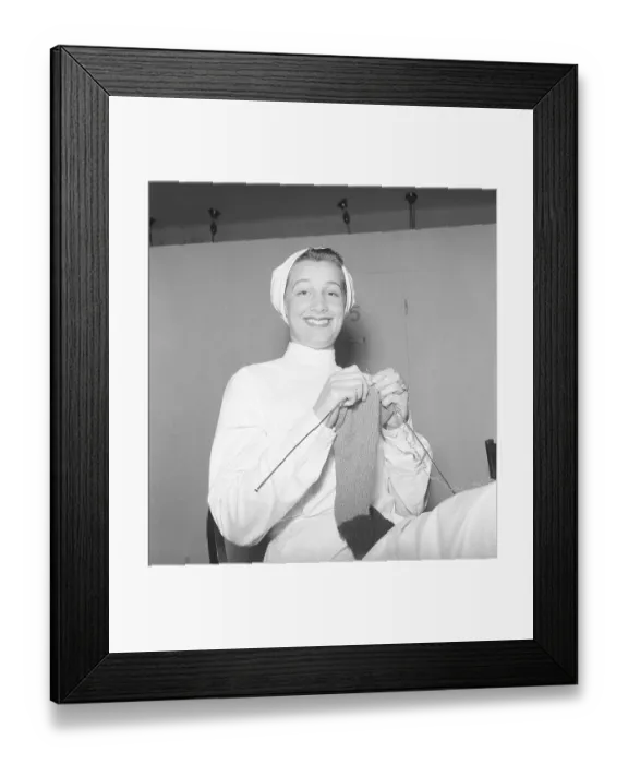 Framed Print : In the 1940s. A young woman is sitting on a chair and knits. 1943. Kristoffersson ref E77-5