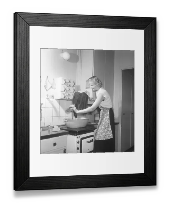 Framed Print : This is how it was done in the 1950s. A young woman stands at the kitchen sink and uses Bouvy salt with iodine to dye or wash her clothes. She rinses with clean water and looks pleased with the result. 1951. Kristoffersson ref BB68-2 Framed Print : This is how it was done in the 1950s. A young woman stands at the kitchen sink and uses Bouvy salt with iodine to dye or wash her clothes. She rinses with clean water and looks pleased with the result. 1951. Kristoffersson ref BB68-2