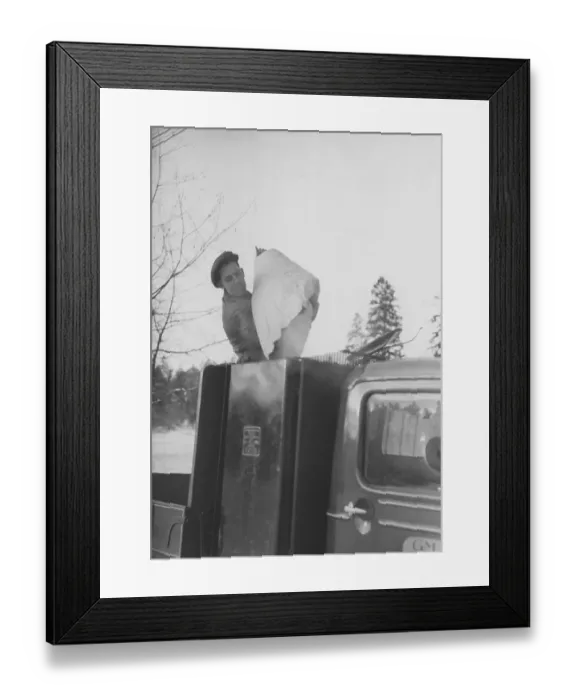 Framed Print : Wood gas 1942. A man fills more coal into the container to fuel the wood gas unit. A natural feature during these years during the World War II was the Wood gasification unit on cars and trucks