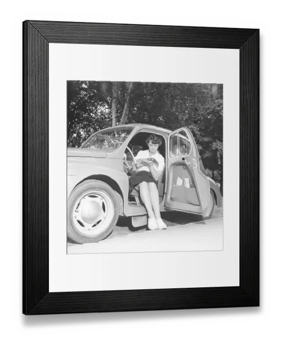 Framed Print : In the 1950s. A woman in the drivers seat of a small car reading a book. 1950 Kristoffersson ref AZ65-6 Framed Print : In the 1950s. A woman in the drivers seat of a small car reading a book. 1950 Kristoffersson ref AZ65-6