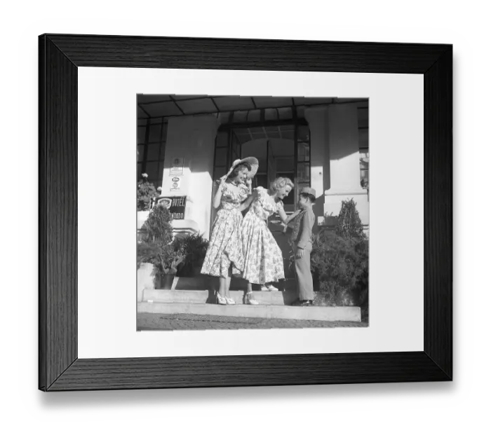 Framed Print : The actresses in Lisbon, Portugal, 1949. Gaby Stenberg (1923-2011) with Margareta Fahlen (1918-1978) in front of a hotel with a bellboy they seem to like very much