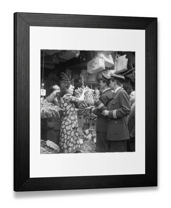 Framed Print : Lisbon, Portugal, 1949. Two swedish airline captains in their uniforms is buying bananas from a store assisted by a girl of the shop staff. Kristoffersson ref AR87-5, Europe Framed Print : Lisbon, Portugal, 1949. Two swedish airline captains in their uniforms is buying bananas from a store assisted by a girl of the shop staff. Kristoffersson ref AR87-5, Europe