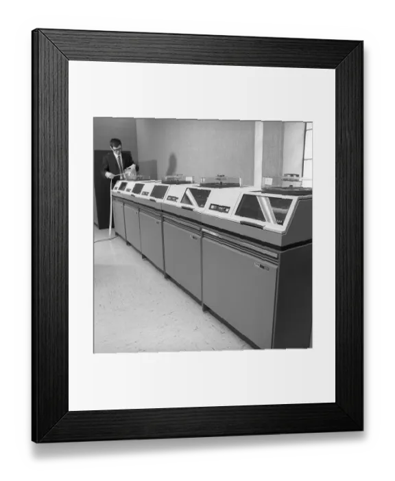 Framed Print : IBM mainframe system 360. A man in a room where some of the computer equipment is visible. The IBM 2311 Direct Access Storage Facility was introduced in 1964 for use in the entire System / 360 family of computers
