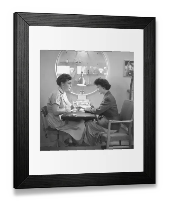 Framed Print : At the manicurist 1955. A manicurist is tending to her nails and applies nail polish of the desired color. October 1955 Framed Print : At the manicurist 1955. A manicurist is tending to her nails and applies nail polish of the desired color. October 1955