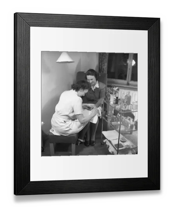 Framed Print : At the manicurist 1945. A manicurist is tending to her nails and files gently. 1945 Kristoffersson ref N108-5 Framed Print : At the manicurist 1945. A manicurist is tending to her nails and files gently. 1945 Kristoffersson ref N108-5