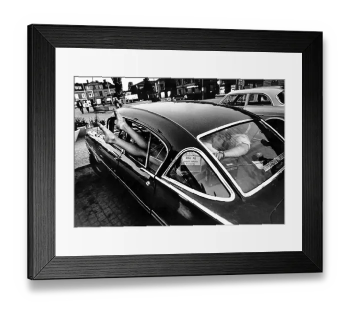 Framed Print : In the 1960s. A vintage american car parked in a square in a small town in Sweden. A typical 1960s youth motor culture of cruising, driving and having fun together often at night. Sweden 1964