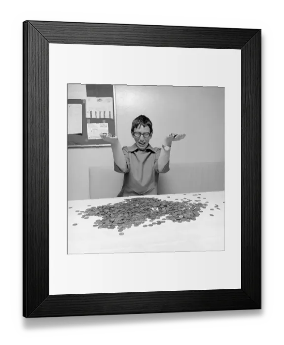 Framed Print : Coins. A woman with a large amount of coins in front of her, looking really happy. 1971. Conard ref 6019