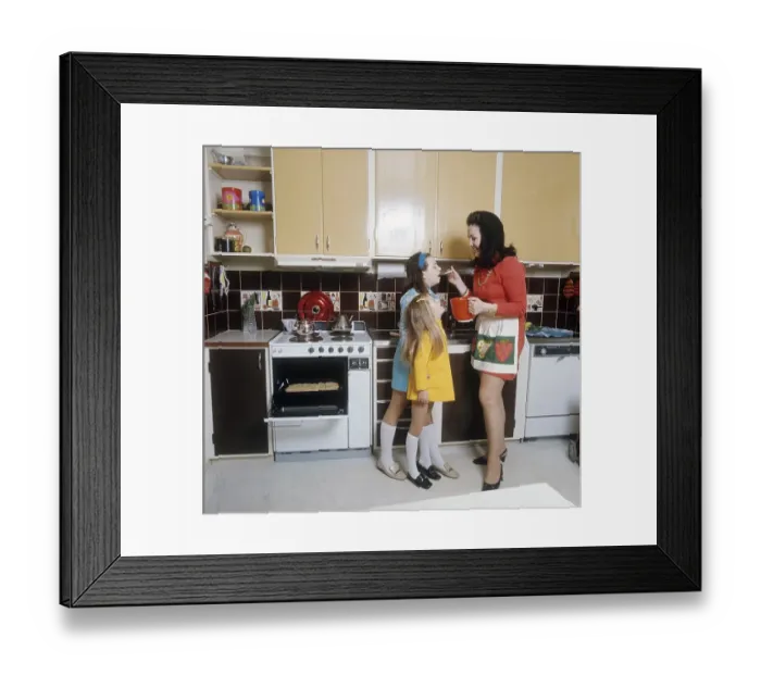 Framed Print : Kitchen 1969. A mother and her two children in the typical 1960s kitchen preparing and baking something in the oven Framed Print : Kitchen 1969. A mother and her two children in the typical 1960s kitchen preparing and baking something in the oven