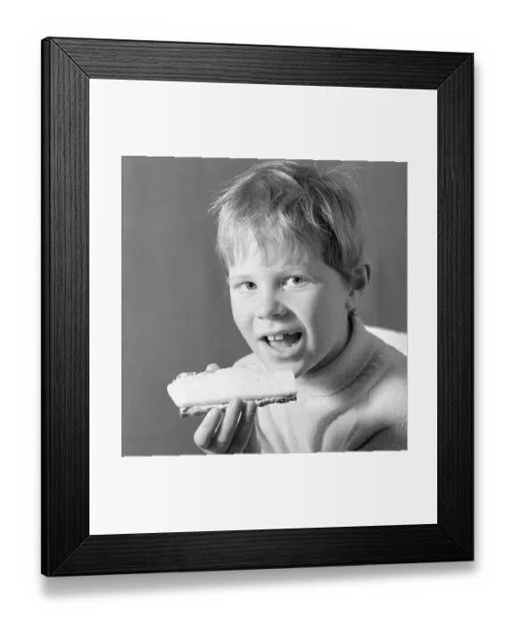 Framed Print : In the 1960s. A boy is eating a cheese sandwich. 1969. Conard ref 5818