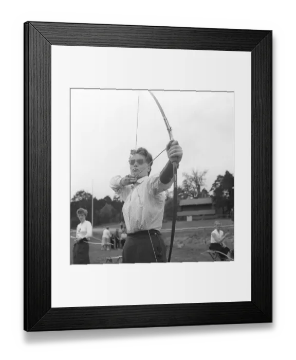 Framed Print : Archery 1957. A woman from the Stockholm archery club with her bow and arrow aims carefully. Kristoffersson Ref BY45-11