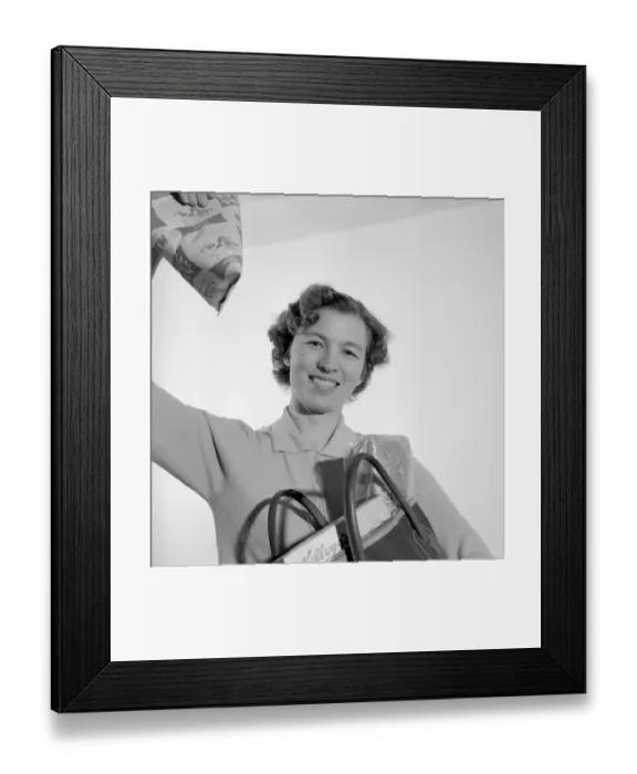 Framed Print : In the 1960s. A woman with her shopping bag Framed Print : In the 1960s. A woman with her shopping bag