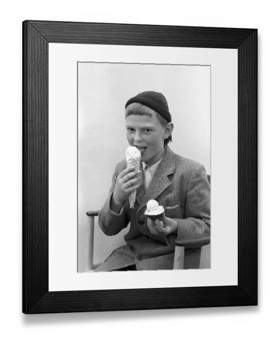Framed Print : 1950s boy eating ice cream. A boy with a large cone of vanilla ice-cream enjoys it Framed Print : 1950s boy eating ice cream. A boy with a large cone of vanilla ice-cream enjoys it